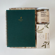 Load image into Gallery viewer, Holiday gift box with Mimi and August Foresta pine scented candle in a reusable mug, Lake and Oak Vanilla Cookie Calm Tea blend with chamomile, cinnamon, vanilla, and toasted coconut. Baltic Club lined journal in emerald green, a ready to ship gift box for calm winter mornings